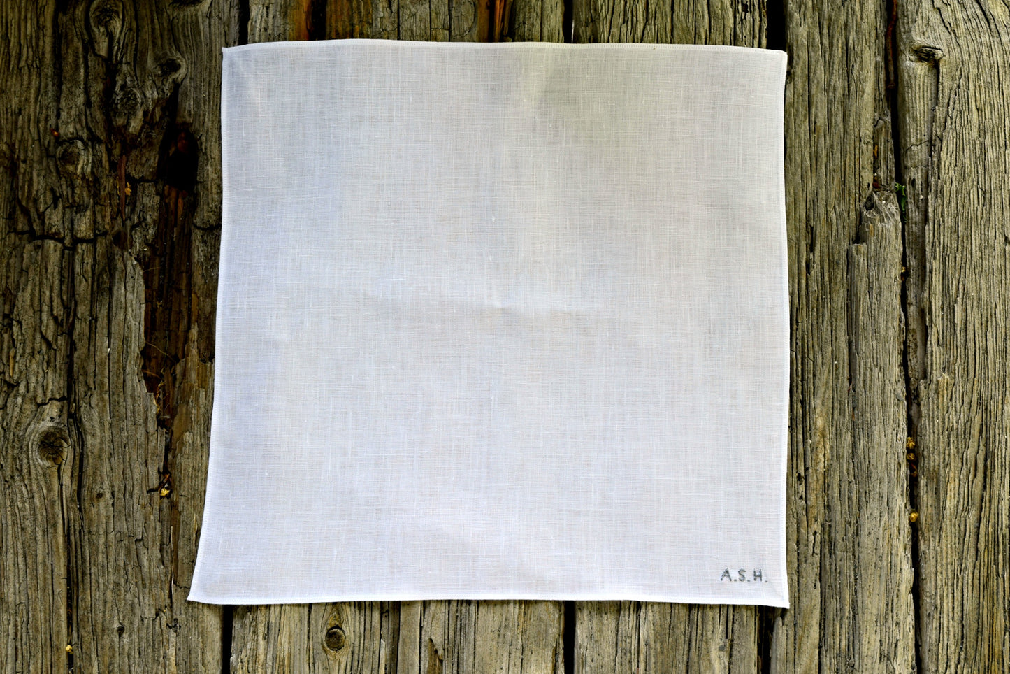 White linen pocket square hand embroidered with tiny monogram