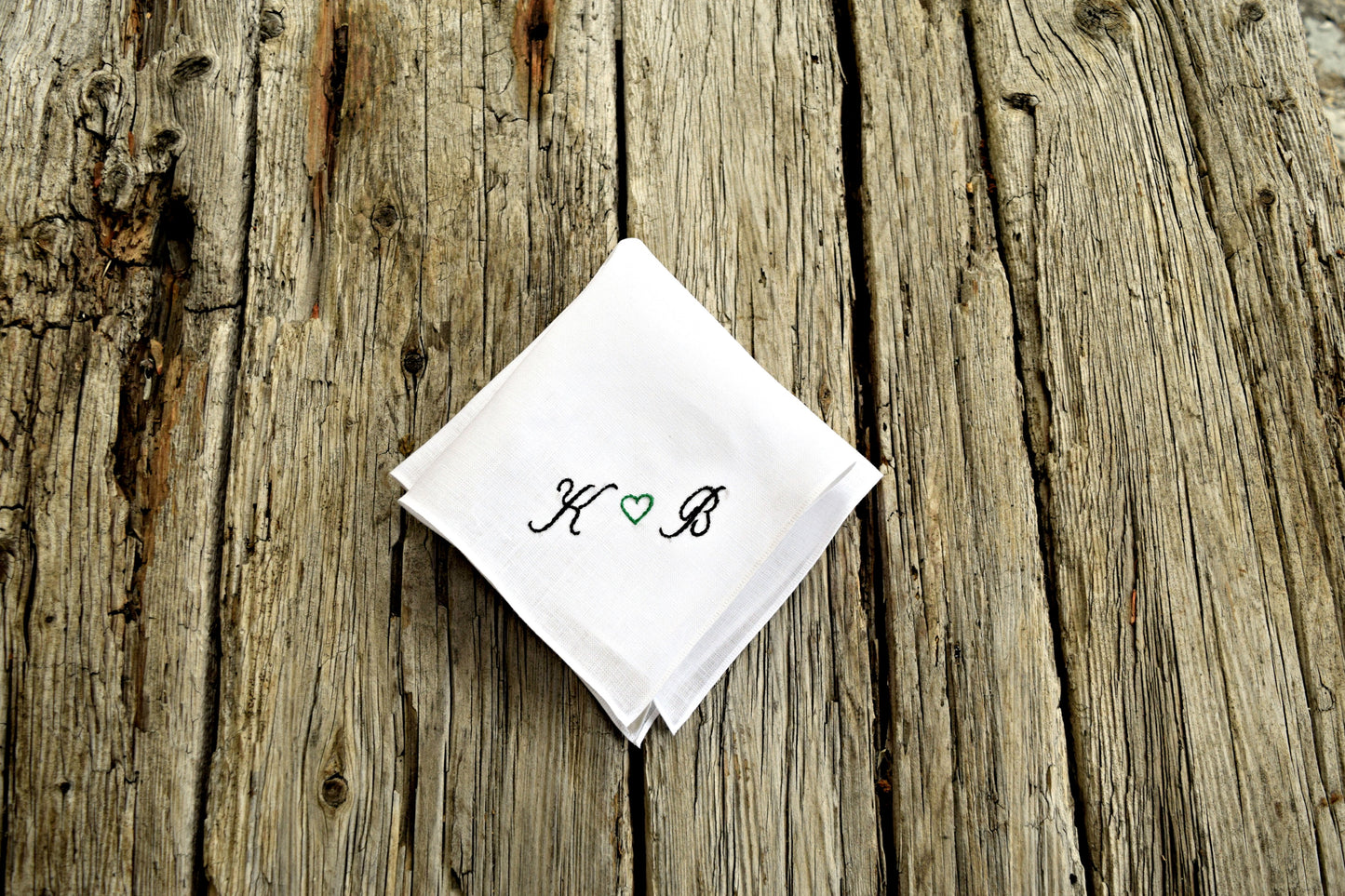 White wedding pocket square with sweetheart design on wood background