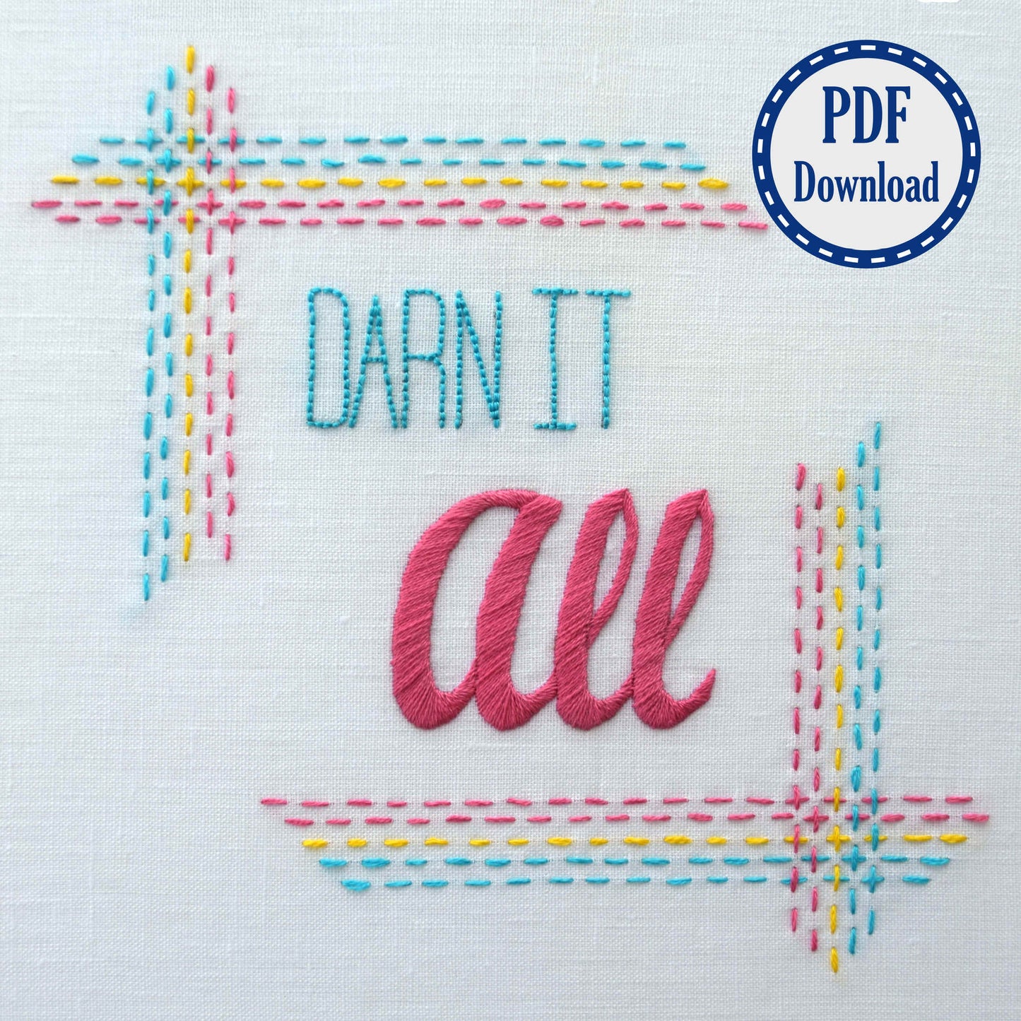 Closeup of Darn it All embroidery design on white linen. Frame is square and made of lines of running stitch in rainbow colors. Lettering is back stitch and satin stitch for a modern look.