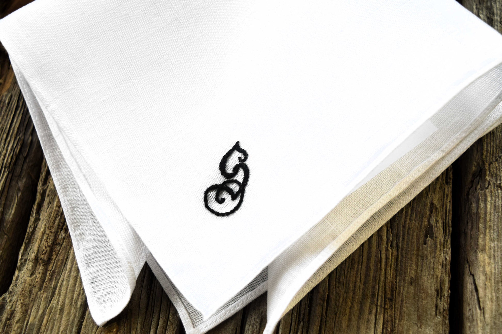 fairytale monogram hankie on wood background