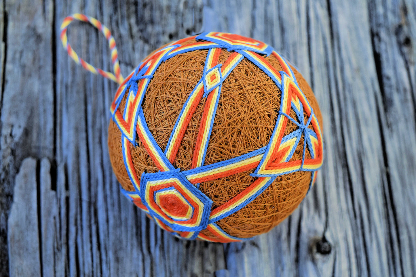 Japanese gold temari ball with orange and blue design