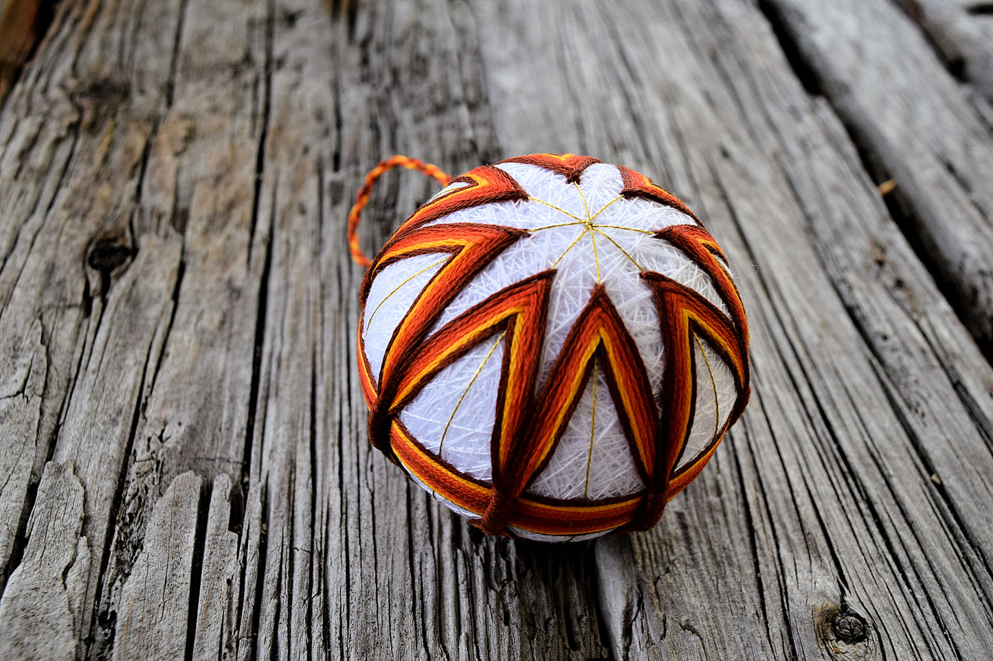 Harvest colored temari ball on wood background
