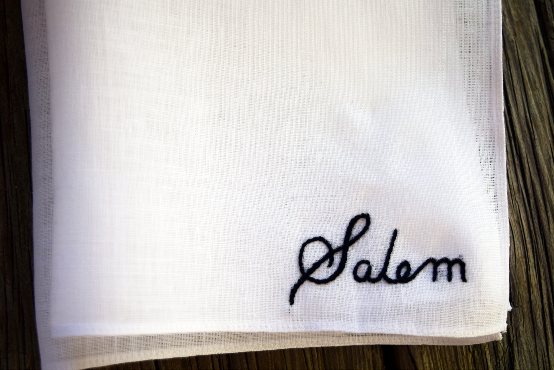 White linen handkerchief with embroidered name