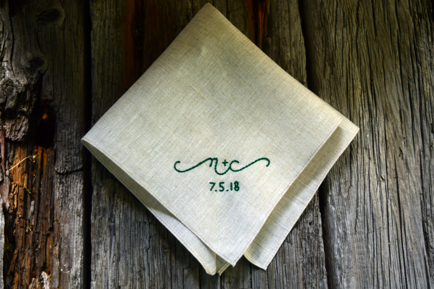 Oatmeal linen sweetheart handkerchief on wood boards