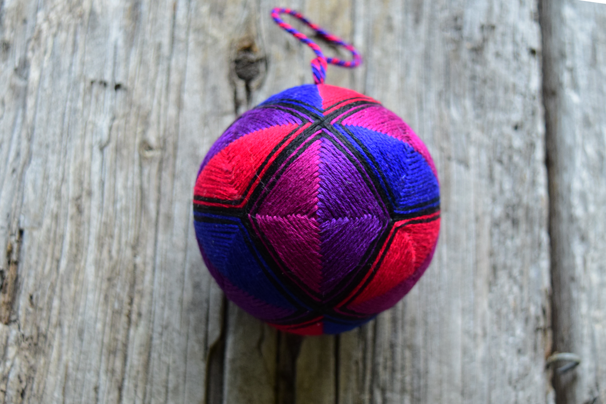 Japanese temari ball stitched in jewel tone triangles