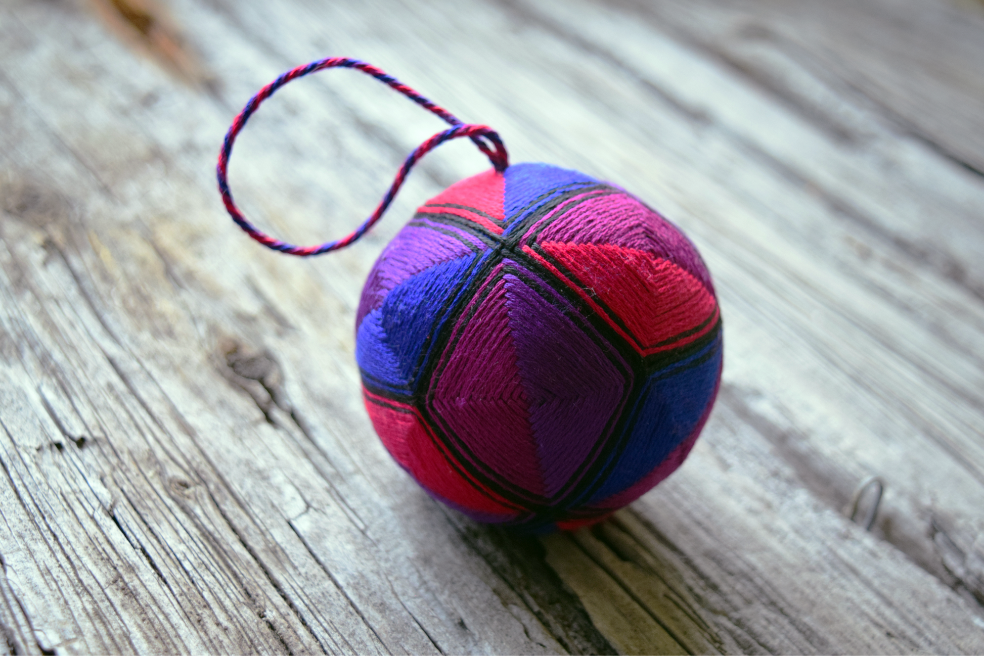 Kousa temari ball in stained glass colors outlined in black thread