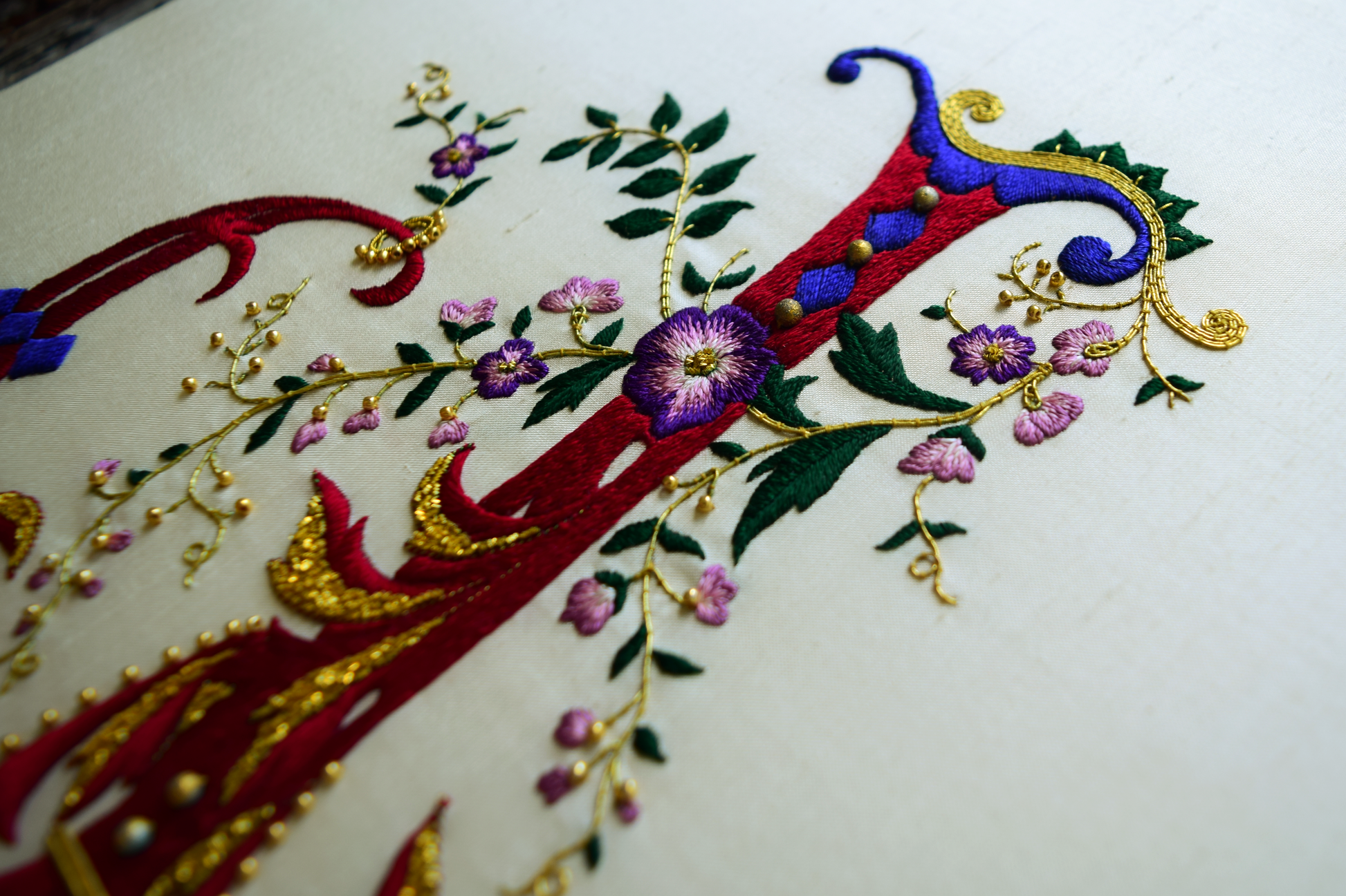 Side view of ornate french letter with floral and gold accents 