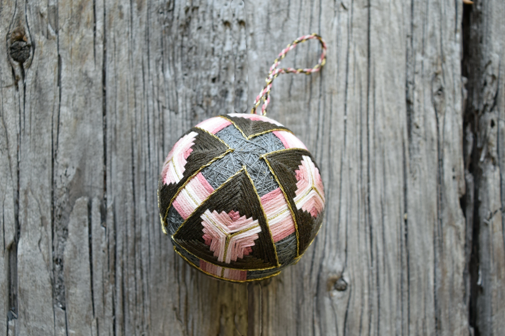 Temari ball in dusty rose and neutral shades hand embroidered and accented with gold