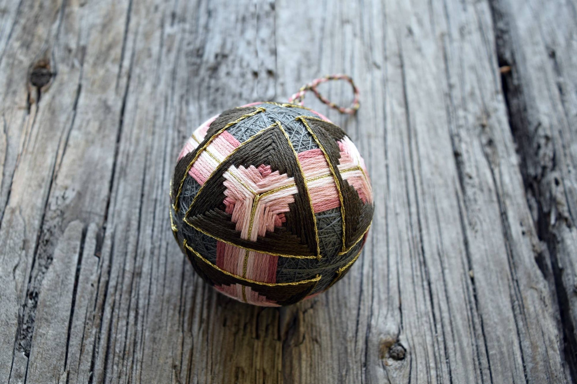 Brown and pink temari ball with golden accents