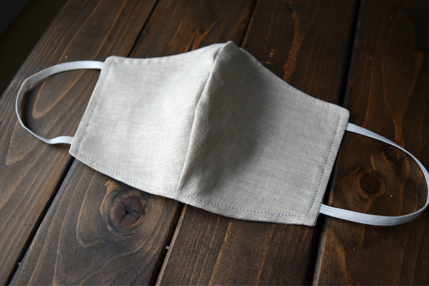 Side view of oatmeal linen face mask with elastic loops