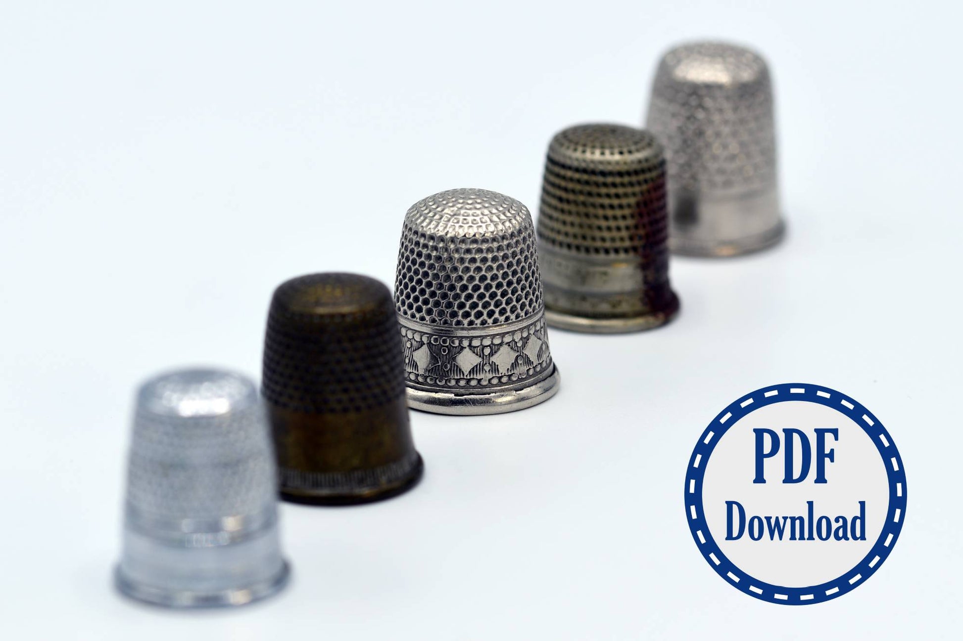 Line of antique thimbles in various sizes and patterns