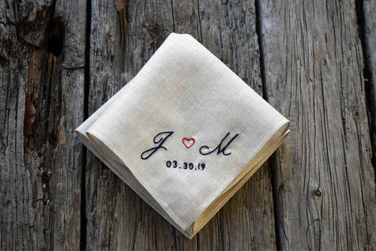 Oatmeal Irish linen handkerchief hand embroidered with "J (heart) M 003.30.19" in black with a red heart