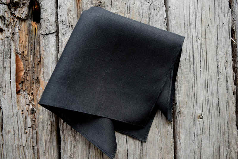 Black Irish linen handkerchief partially unfolded