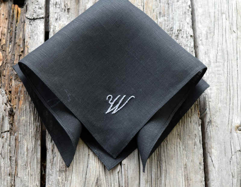 Black linen hankie partially unfolded showing hand monogrammed W in script