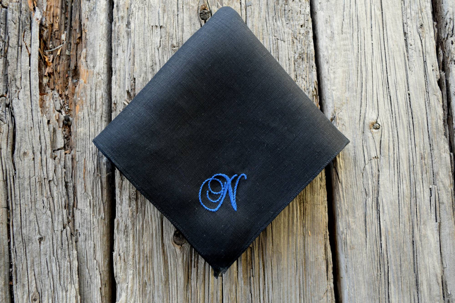 Black linen pocket square hand embroidered with letter N in blue
