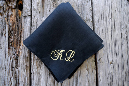 Black linen handkerchief hand embroidered with yellow KL in antique cursive script