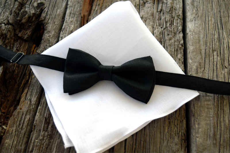 Black linen adjustable bow tie on folded white linen handkerchief