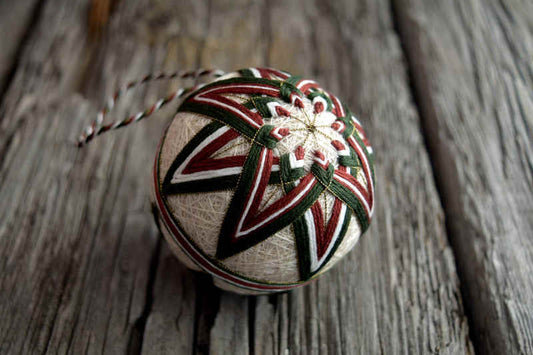 Green and brown kiku temari with eight pointed layered star and gold marking threads