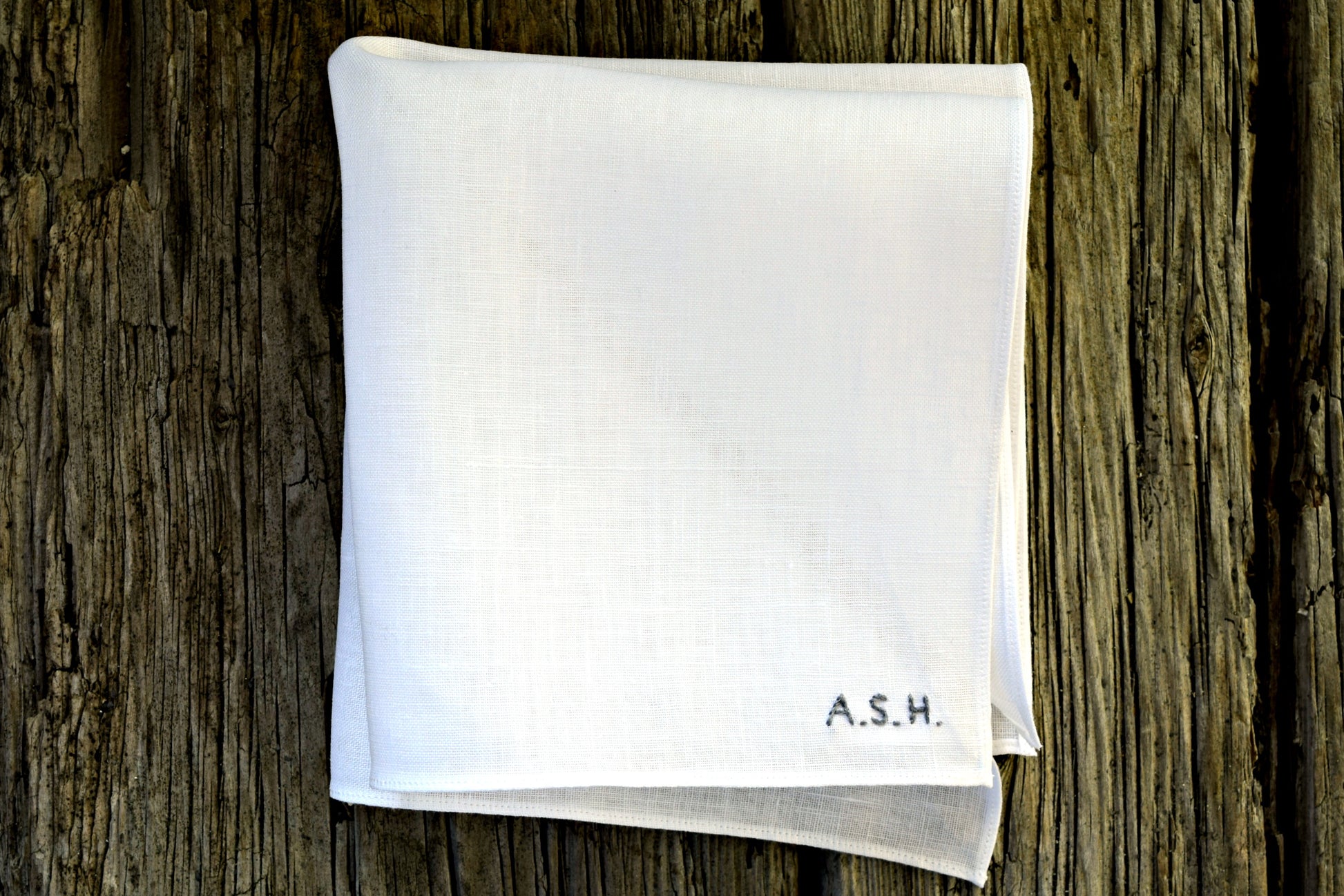 White linen handkerchief personalized with tiny block letter initials