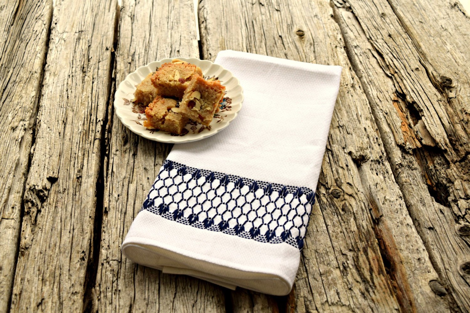 Kitchen tea towel in white huck embroidered with a band of navy diamonds