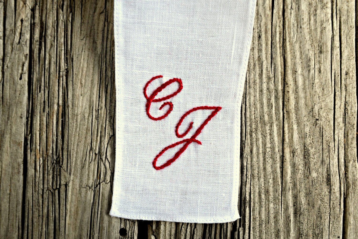 Closeup of linen bookmark personalized with two monogram initials