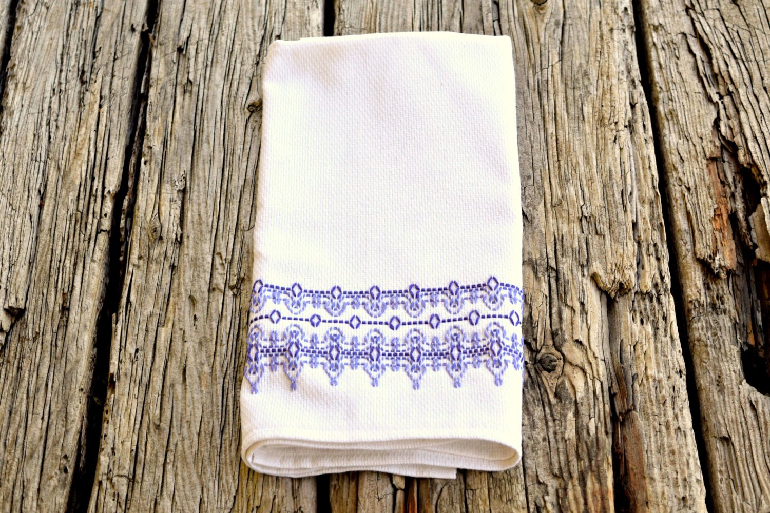 White huck kitchen towel embroidered in soft purple