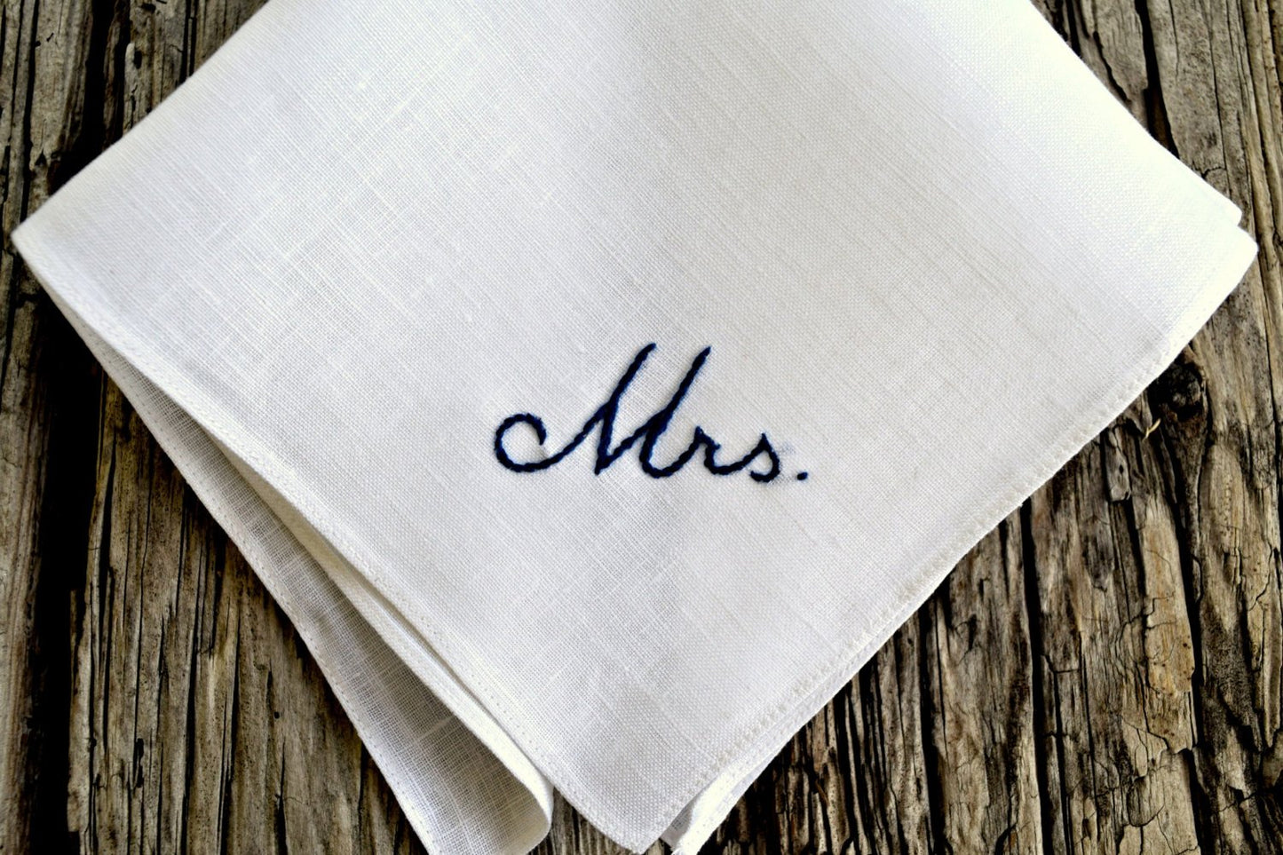 Close up of hand embroidered handkerchief with Mrs. design in navy