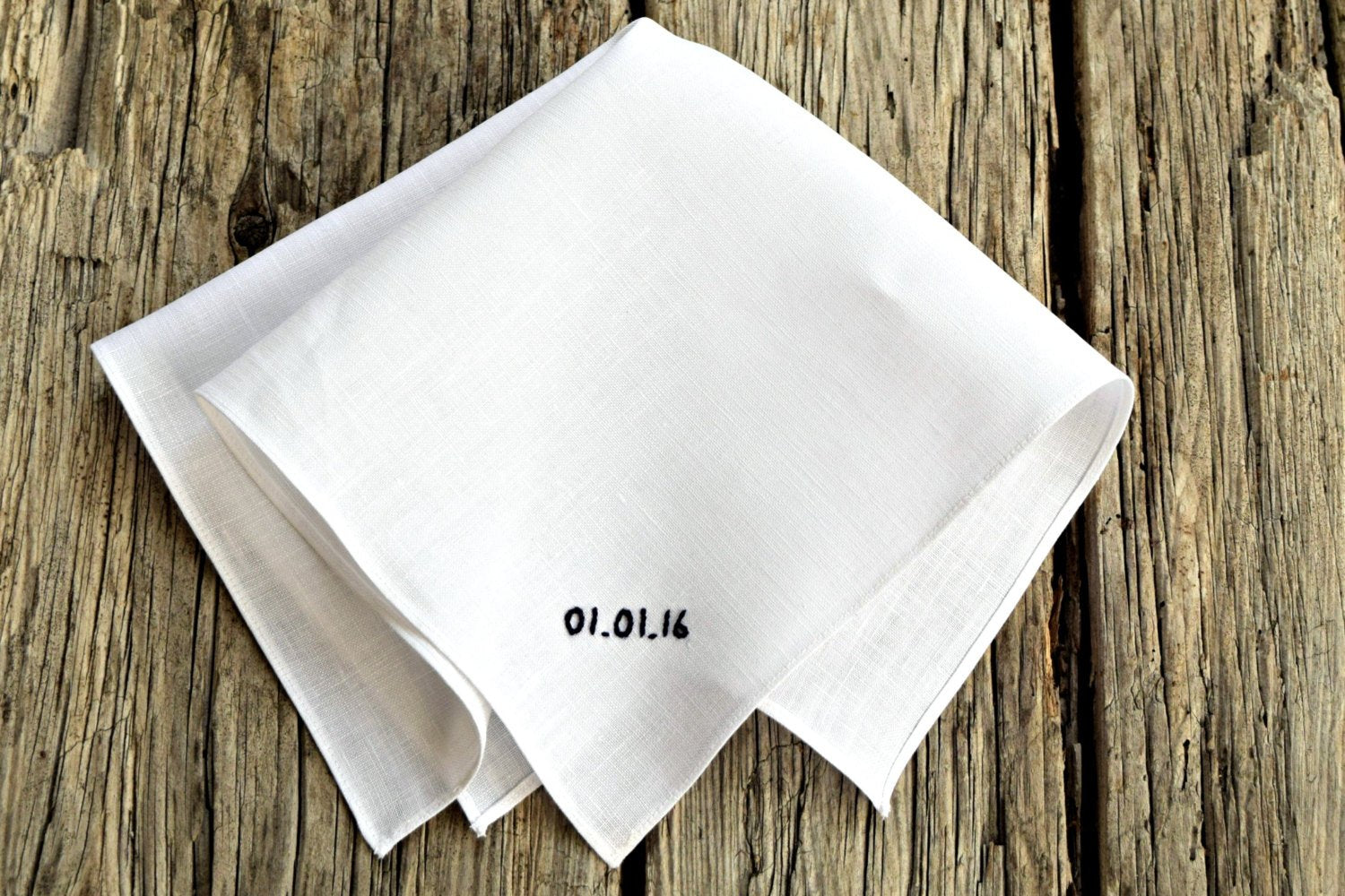 White linen handkerchief hand embroidered with wedding date in black