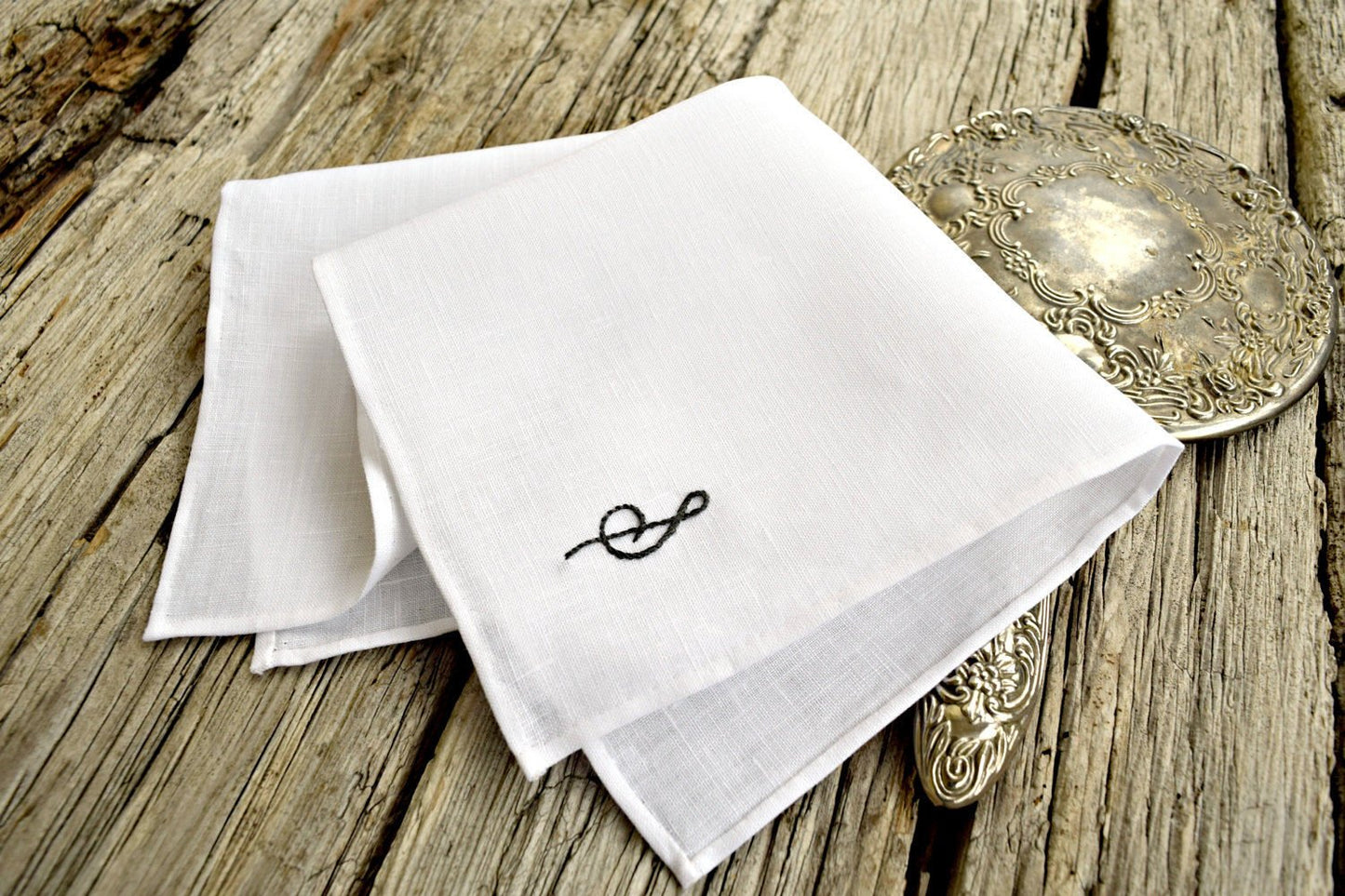 Closeup of Irish linen handkerchief showing hem detail and hand embroidered letter
