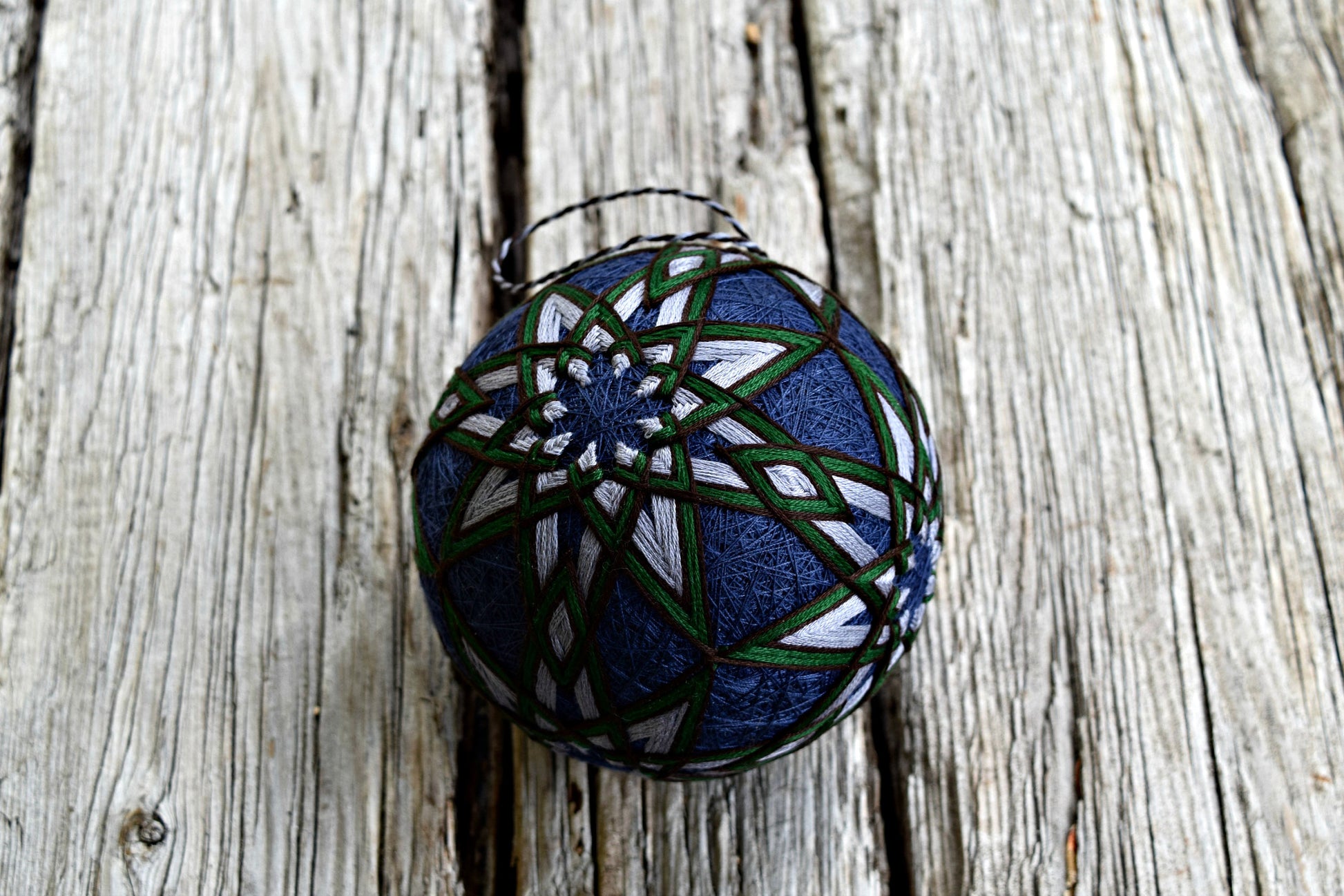 Japanese temari ball ornament embroidered in all over eight pointed stars in green and grey