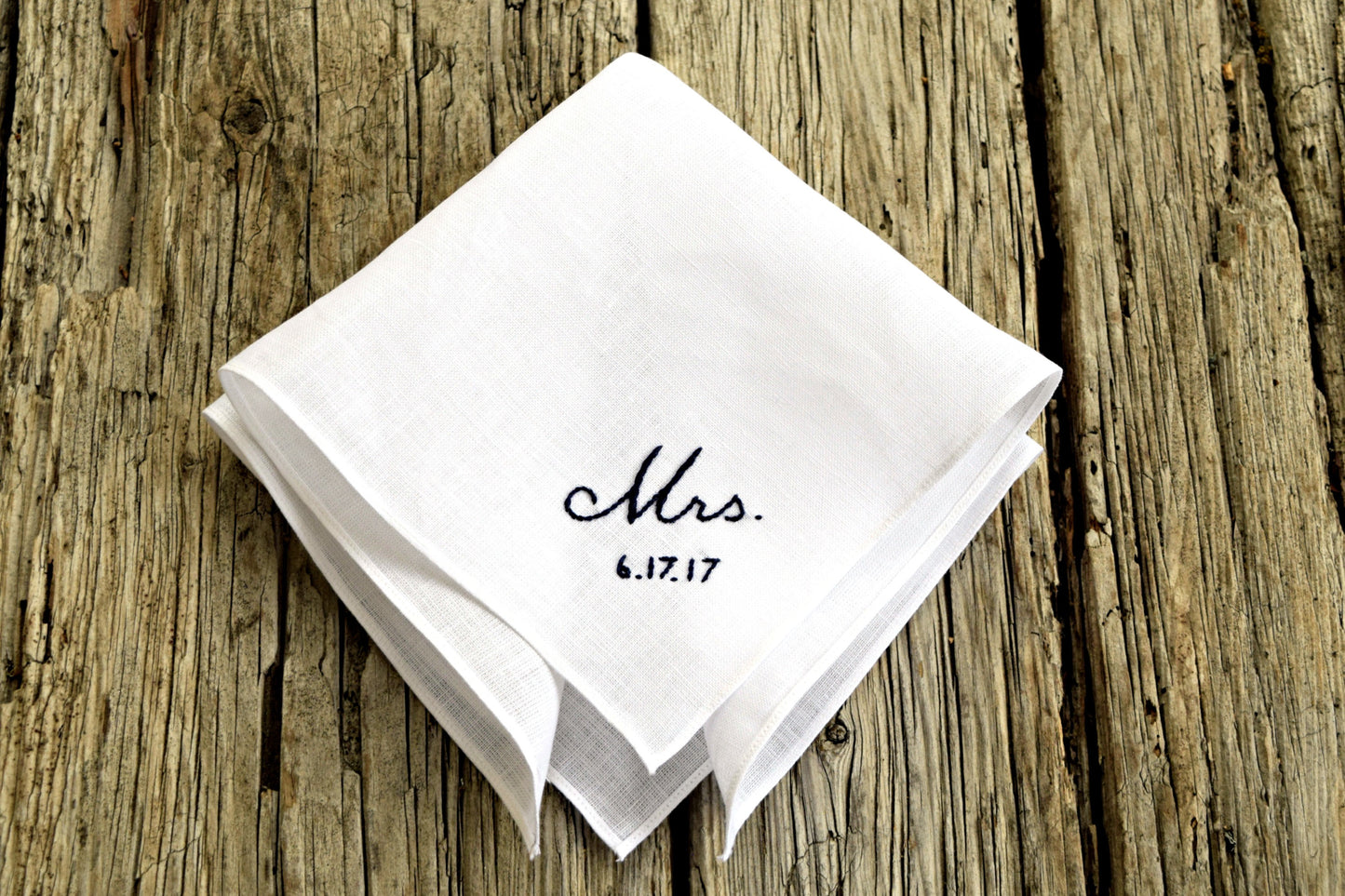 White linen hankie hand embroidered with Mrs and a wedding date in black