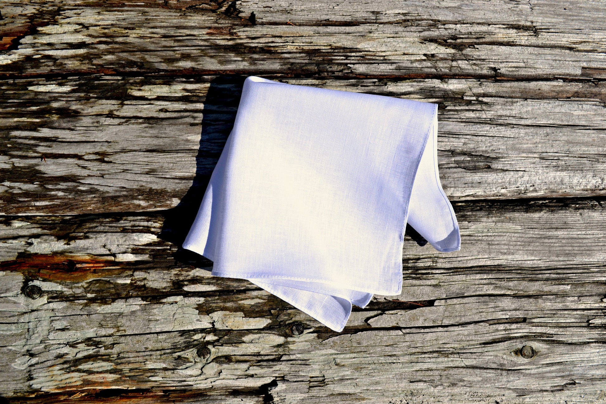 White Irish linen handkerchief on wood ground