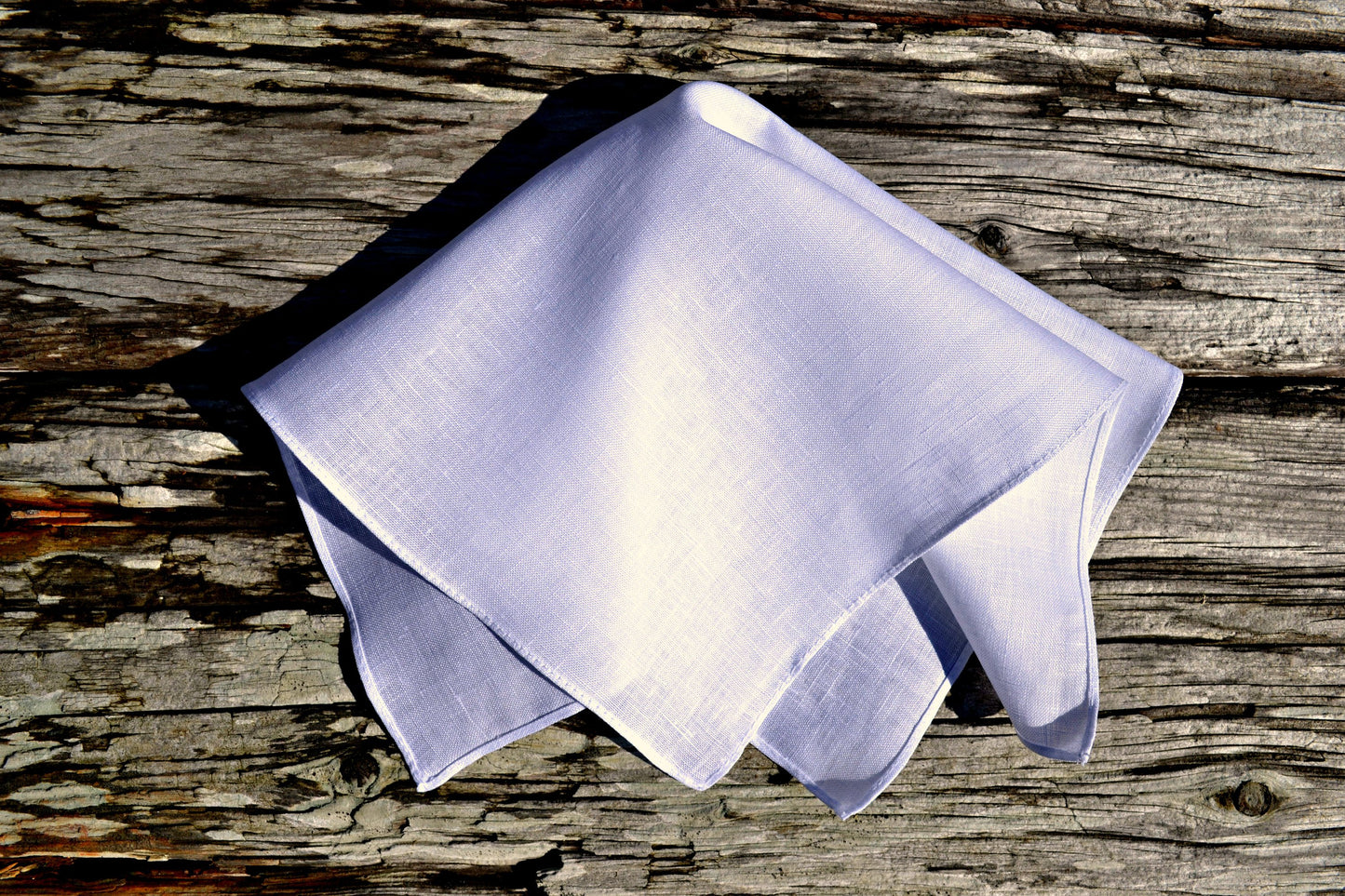 Irish linen handkerchief in white on wood background
