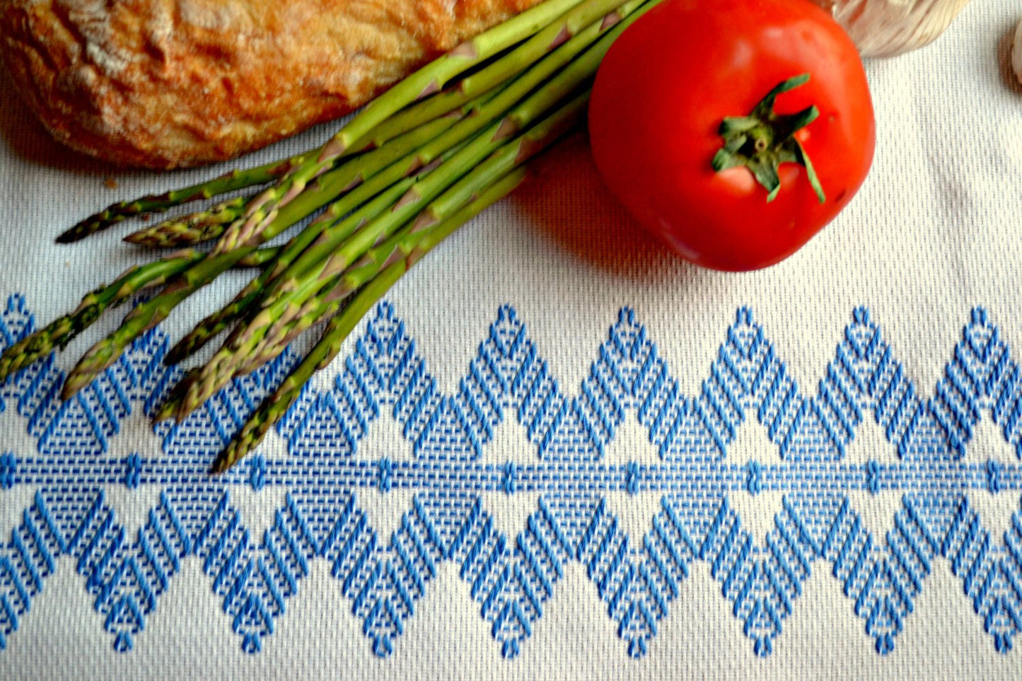 Hand embroidered white and blue tea towel with vegetables