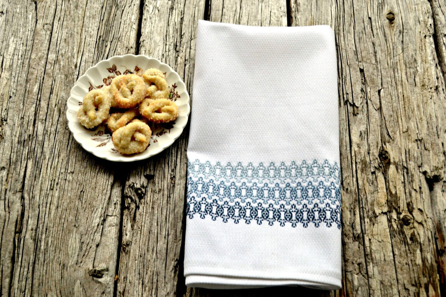 Huck embroidered tea towel in shades of soft blues