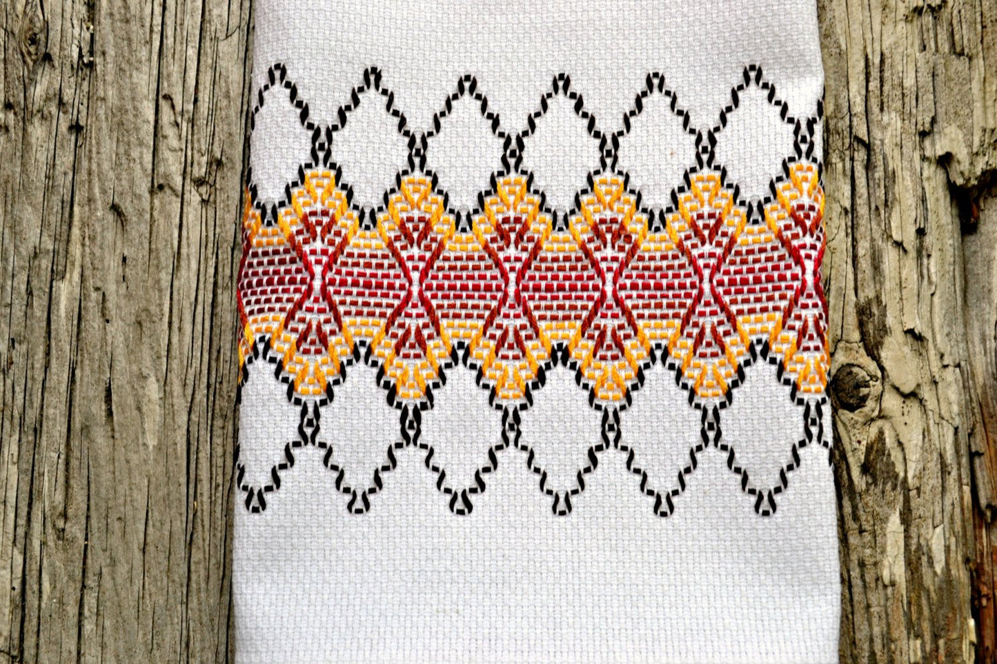 White huck kitchen towel with hand embroidered design in fall colors