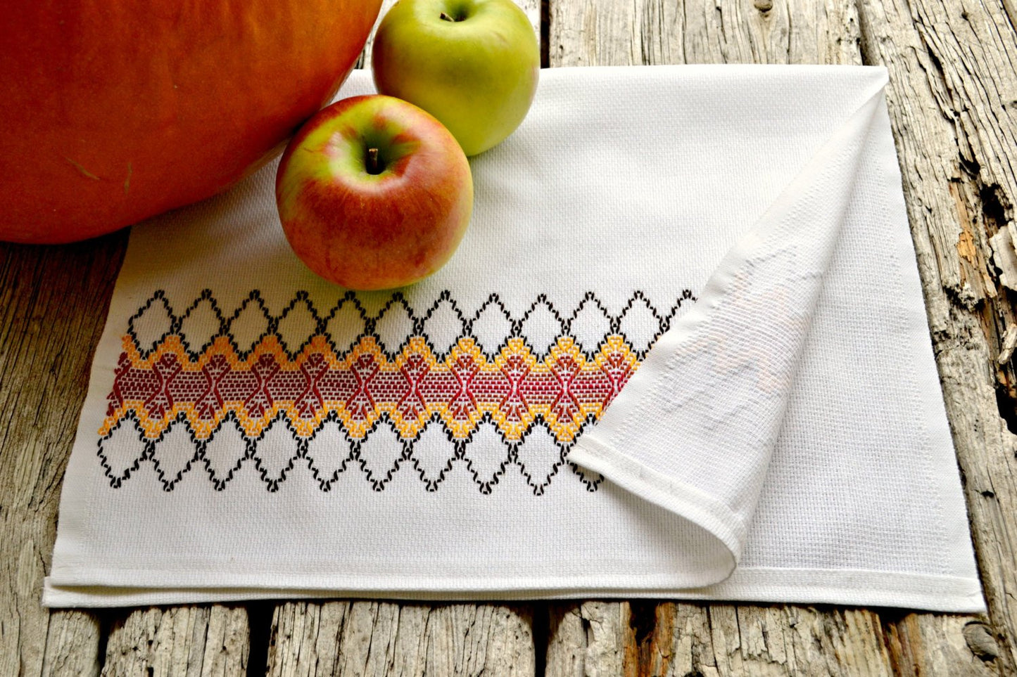 Huckaback tea towel stitched in harvest colors with apples