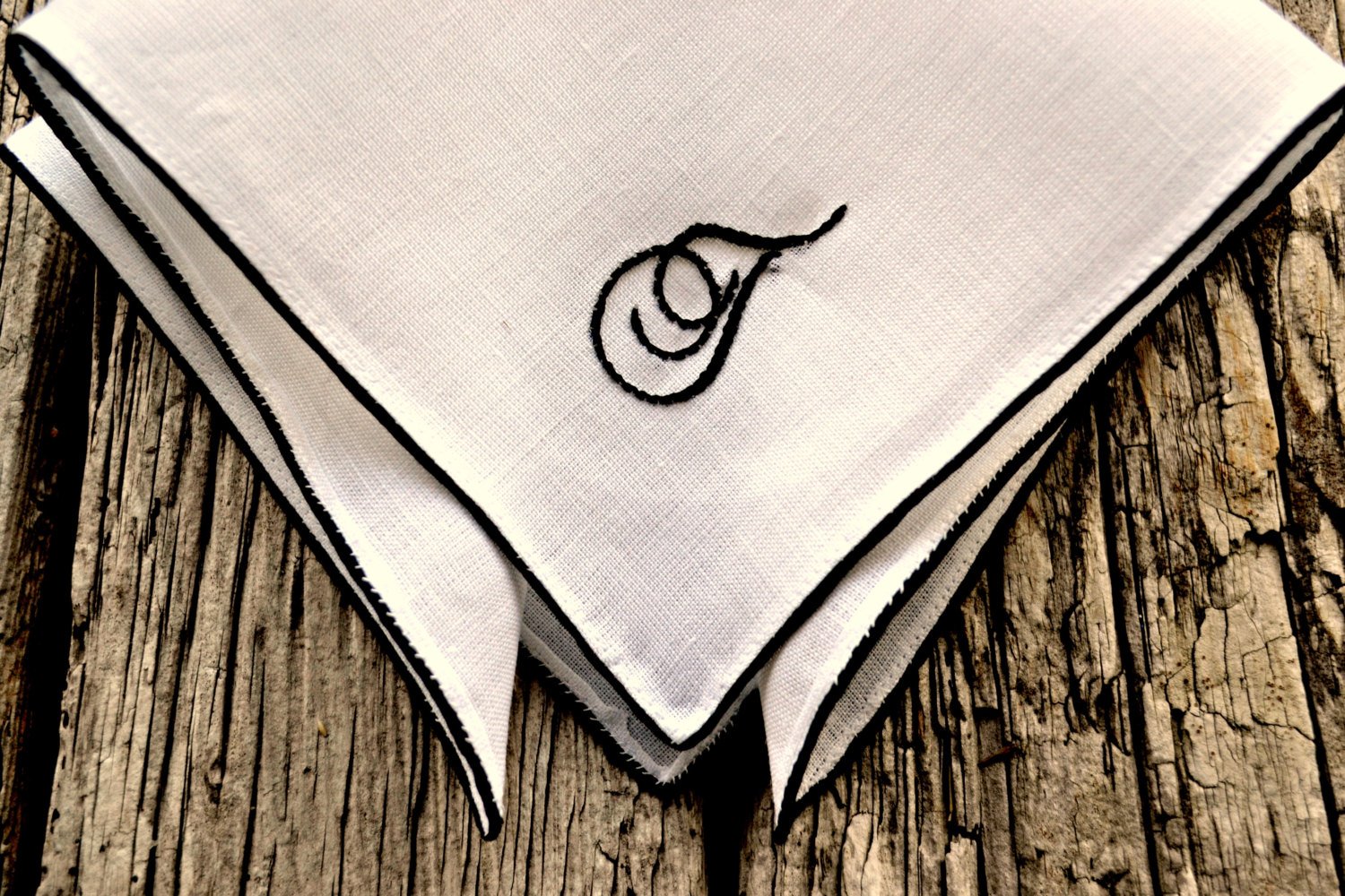 Closeup of hand embroidered pocket square showing stitching detail