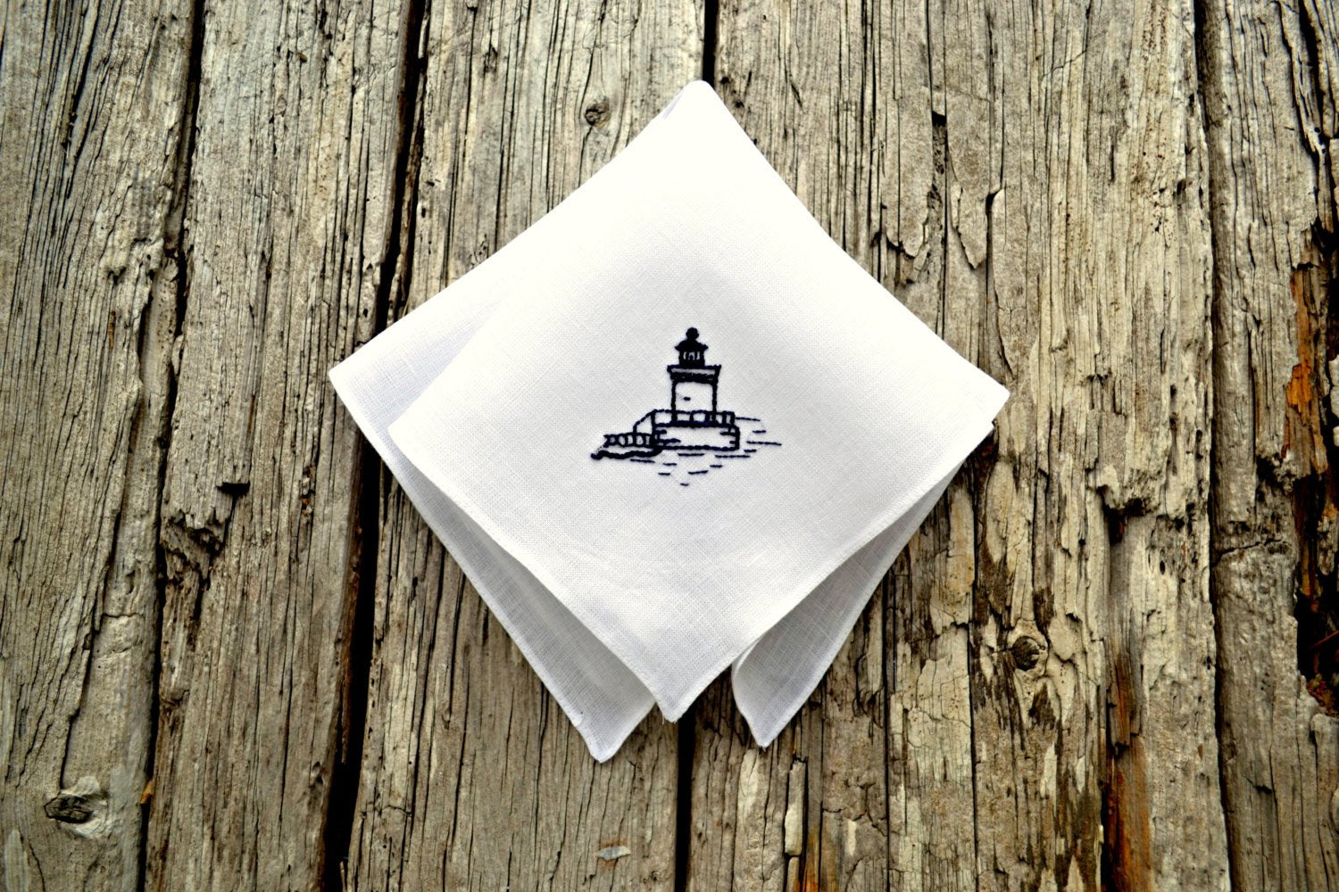 White linen handkerchief hand embroidered with Maine lighthouse