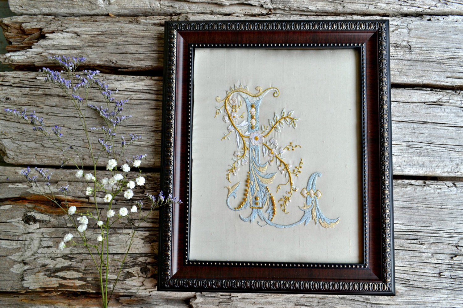Ornate hand embroidered letter L worked in pastel shades of silk and gold metal threads on silk dupioni