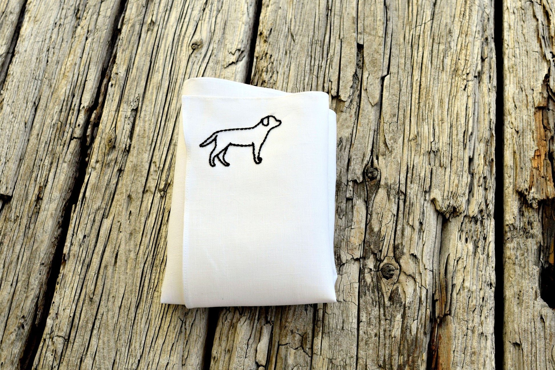 Black labrador retriever dog outline embroidered onto one corner of white linen pocket square