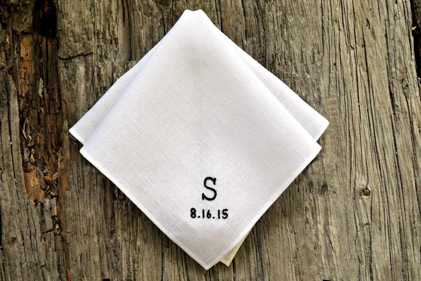 White linen handkerchief hand embroidered with custom monogrammed initial and wedding date