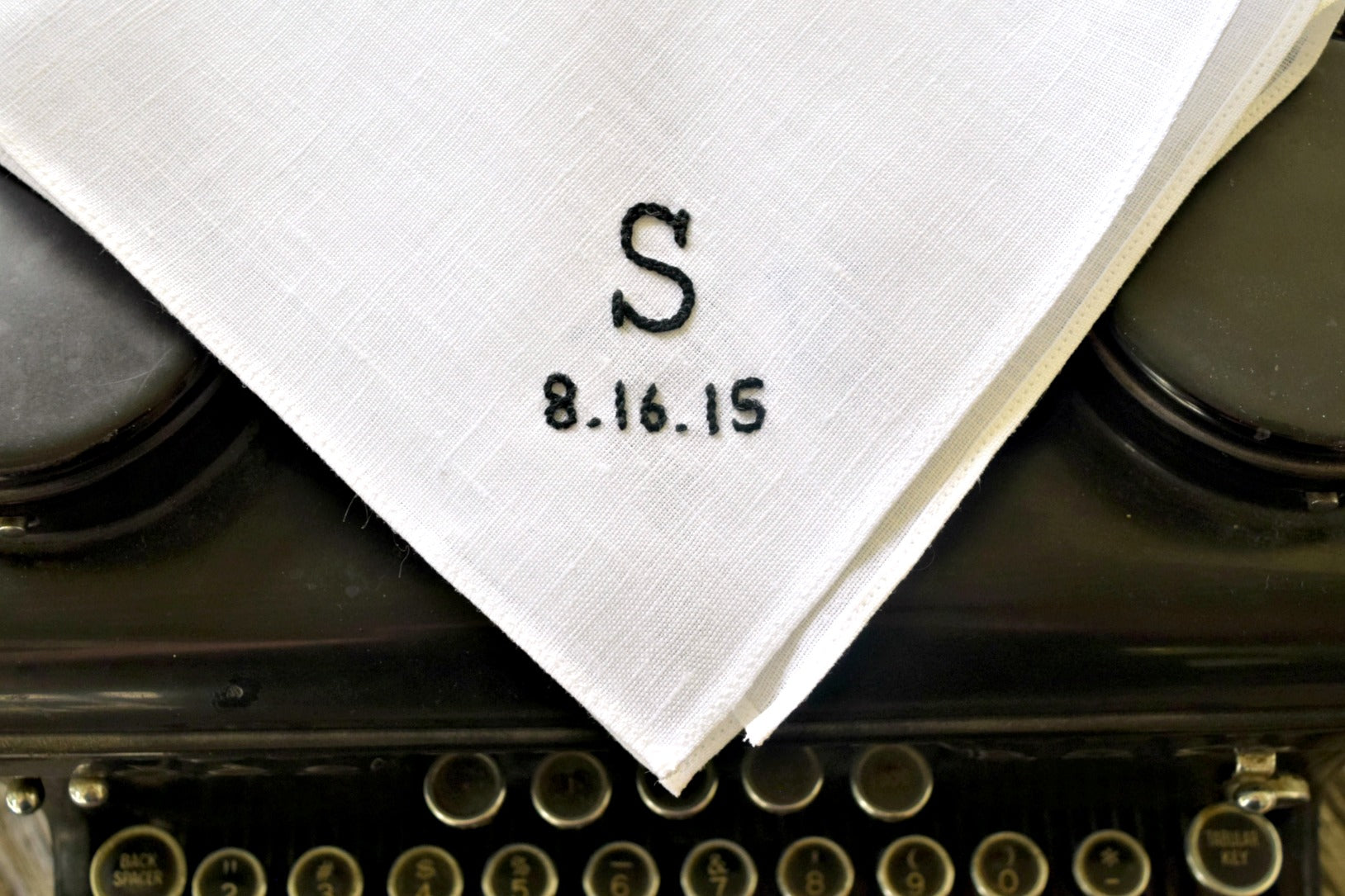 Hand embroidered pocket square with monogram and date in typewriter font