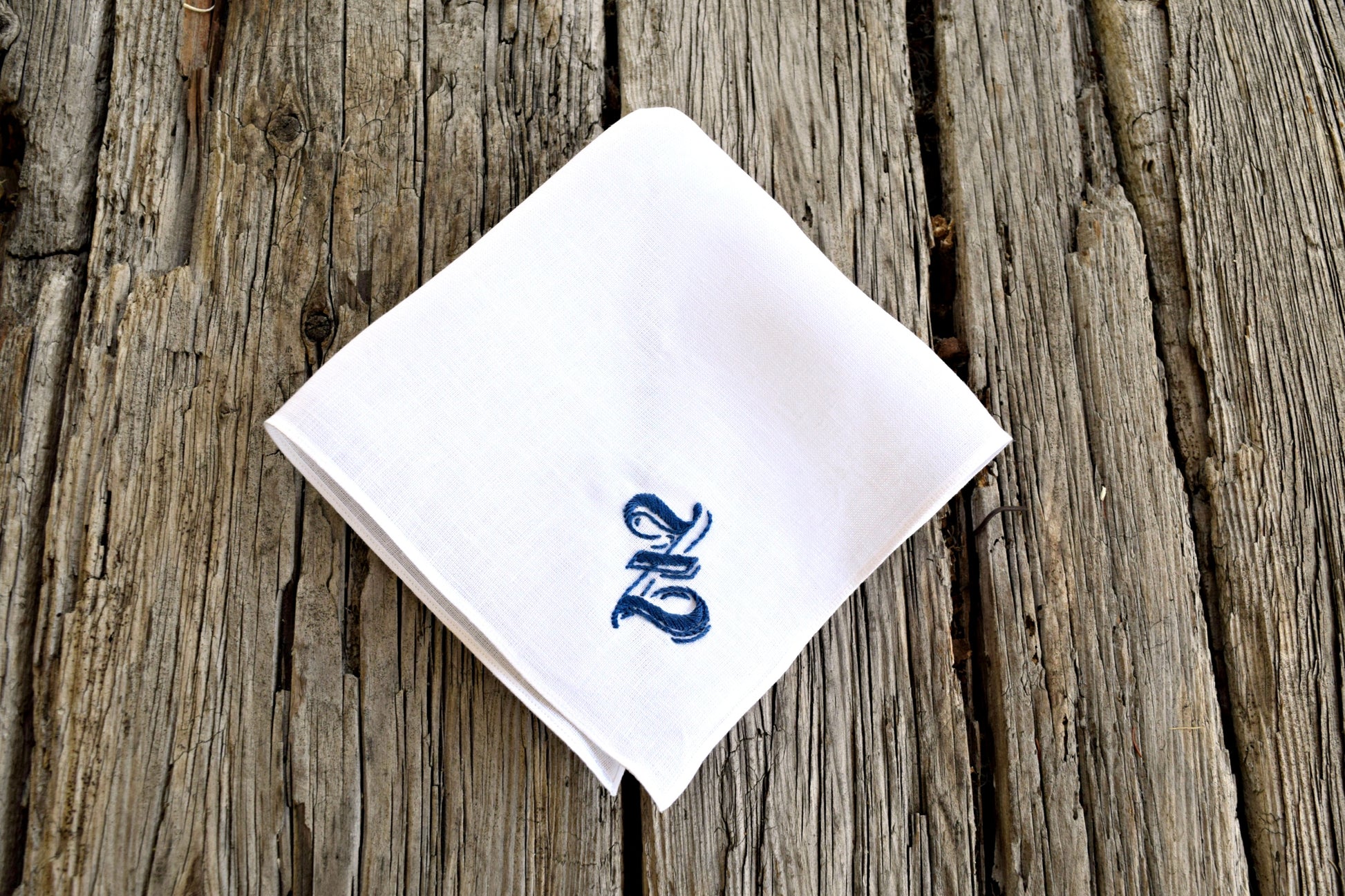 White linen handkerchief with ornate gothic z embroidered in blue