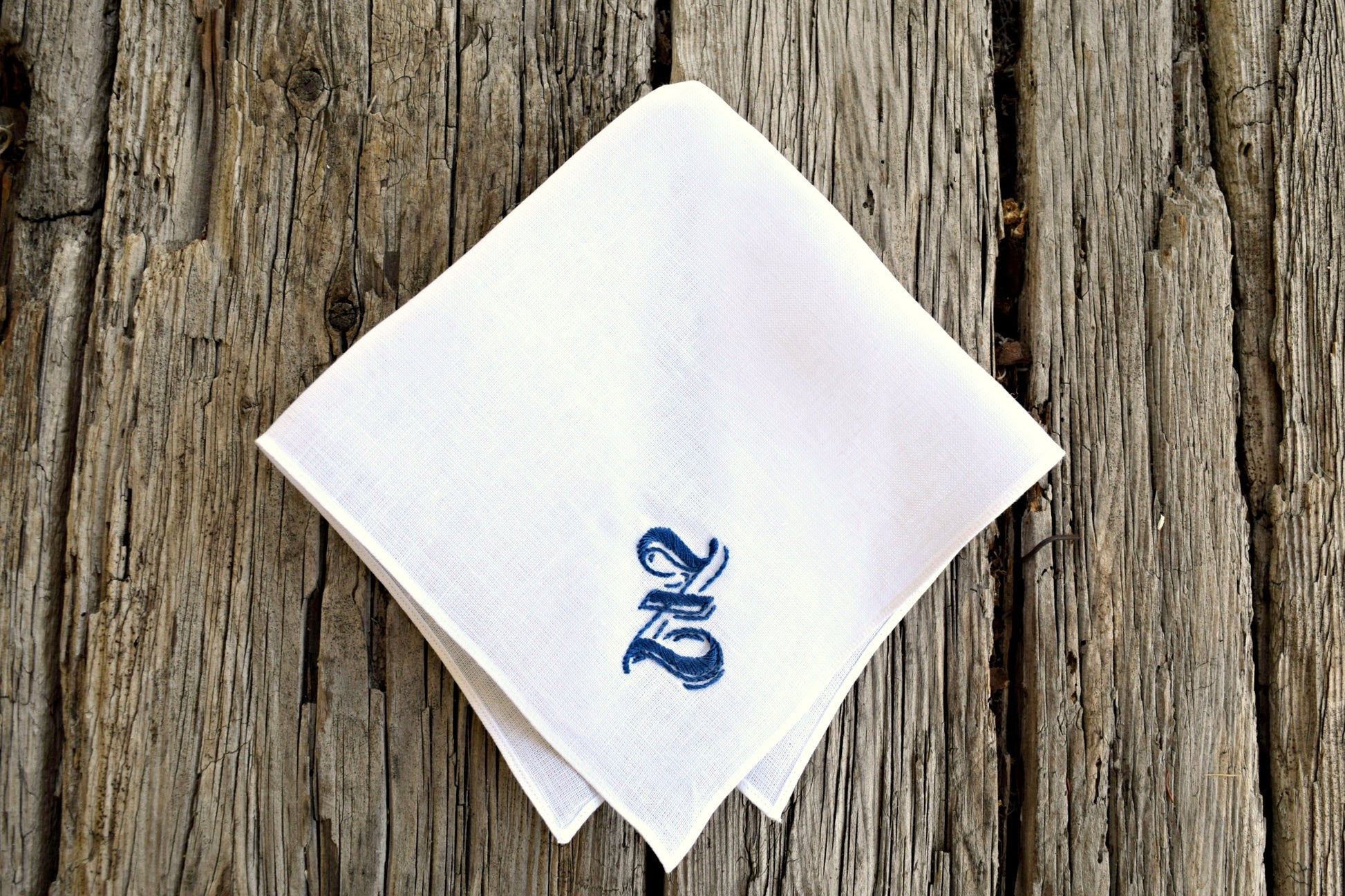 White pocket square embroidered with large fancy letter Z